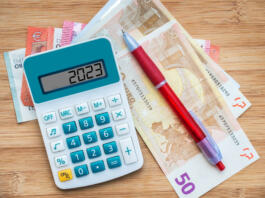 2023 numbers on a calculator and euros banknotes, new year finance, money inflation and budget concept