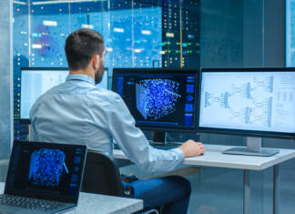 Vodič po nakupu monitorja (del 2): velikost in ločljivost Beautiful Male Computer Engineer and Scientists Create Neural Network at His Workstation. Office is Full of Displays Showing 3D Representations of Neural Networks.