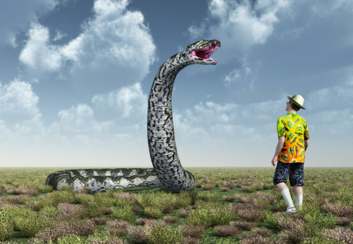Computer generated 3D illustration with man and Titanoboa. Titanoboa is an extinct genus of snakes.