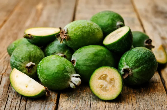 Feijoa on a dark wood background. toning. selective focus