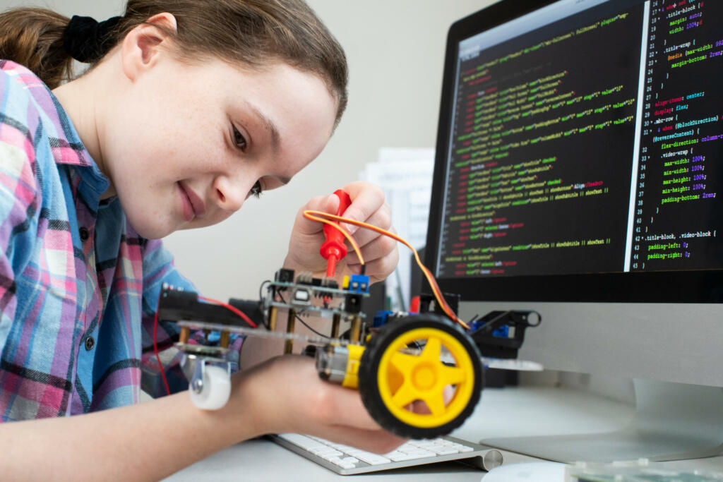 Female Pupil Building Robotic Car In Science Lesson