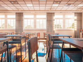 interior of a traditional school classroom with wooden floor and furniture. 3d render