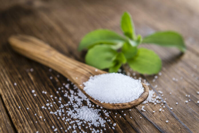 Old wooden table with Stevia Granules (selective focus; close-up shot)