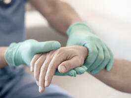 Surgeon, physician performs surgical operations, anesthetist or anesthesiologist holding patient's hand ffor checking state of mand or support in ER room, Medical healthcare concept