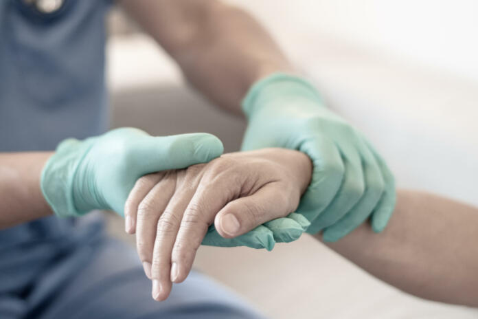 Surgeon, physician performs surgical operations, anesthetist or anesthesiologist holding patient's hand ffor checking state of mand or support in ER room, Medical healthcare concept