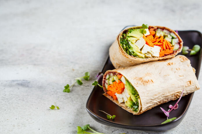 Vegan tortilla wraps with tofu, cucumber, carrots and avocados.