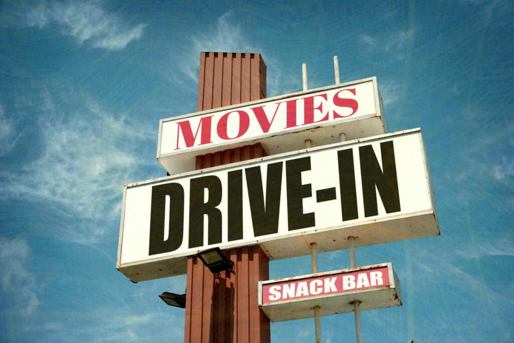 aged and worn vintage drive-in movies sign