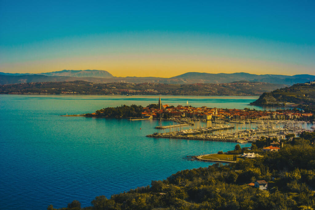 Beautiful view on Adriatic coast,Slovenia, Italy. Seaside,mountain and boat on image. Colorful image. Above area. Izola city.