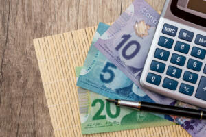 Canadian dollars on wooden desk, macro .