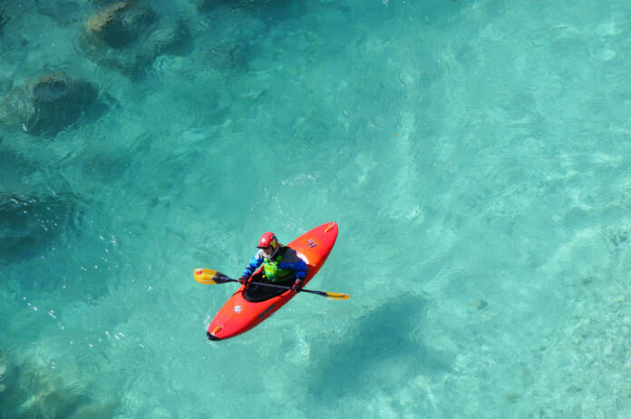 Canoeing on the Beautiful Turquoise Water of Soča River in Springtime. Julian Alps, Kobarid, Slovenia