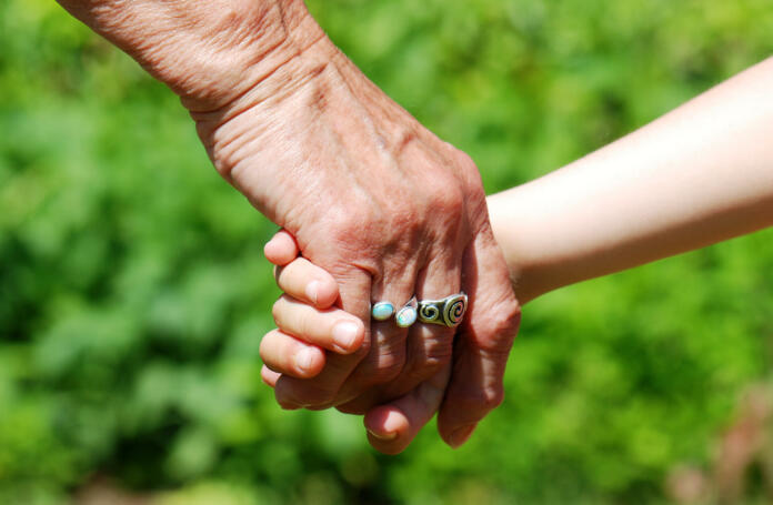 Grandma and child hand in hand together