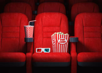Kranj je dobil nov kino! Red cinema seats and cola, popcorn and glasses in empty theater. Cinema movie theater concept background. 3d illustration
