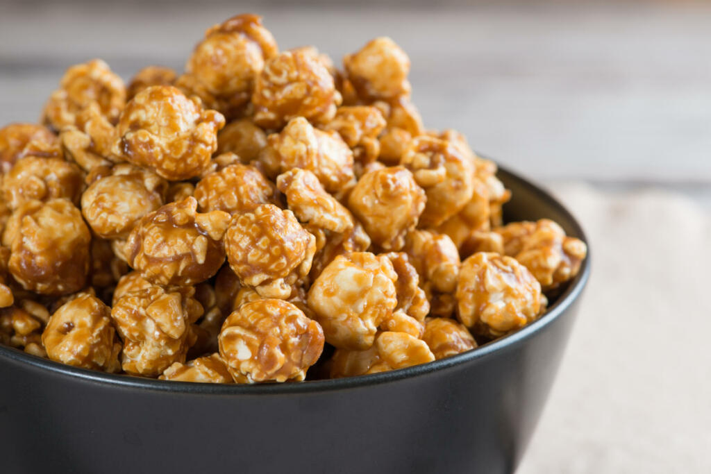 Caramel popcorn on wooden table background
