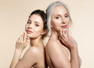Ali so ljudje v preteklosti izgledali starejši? Elderly and young women with smooth skin and natural makeup standing back-to-back. Thinking, planning, dreaming