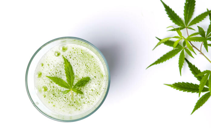Green marijuana smoothie juice on white background