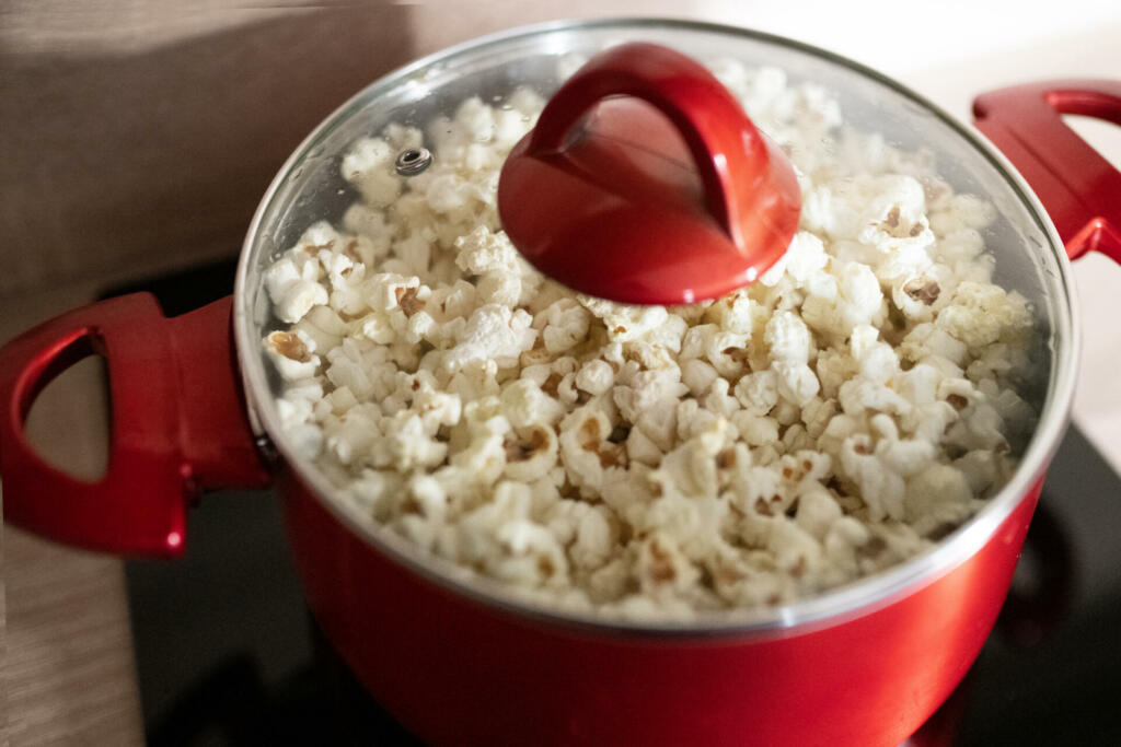 Home made popcorn  in a red pot , popular snack in the cinema.