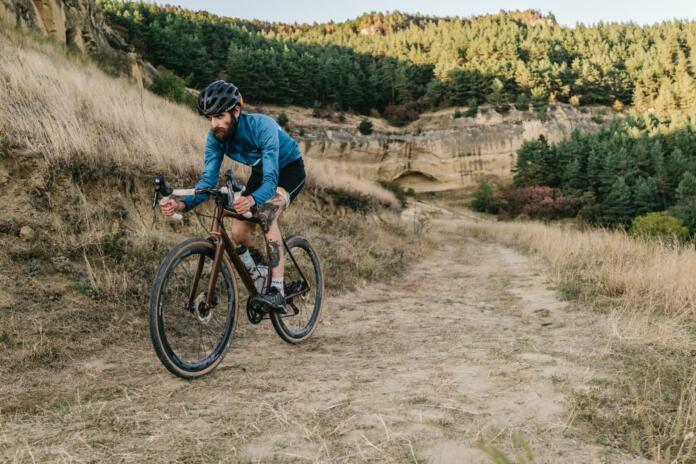 Man cyclist riding road gravel bike