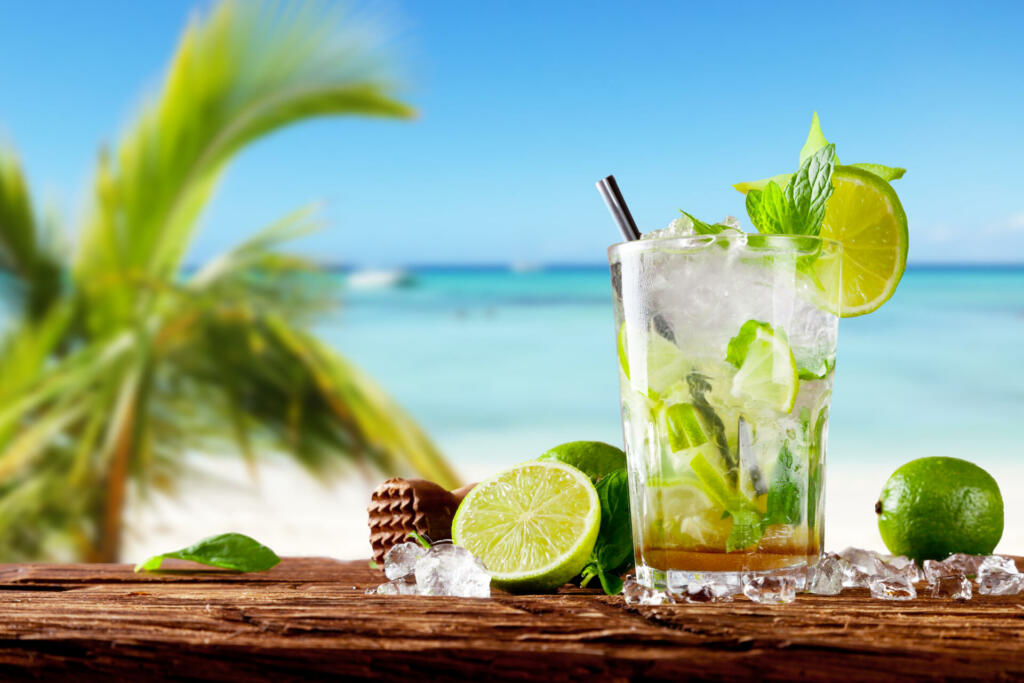Mojito drink on wood with blur beach background