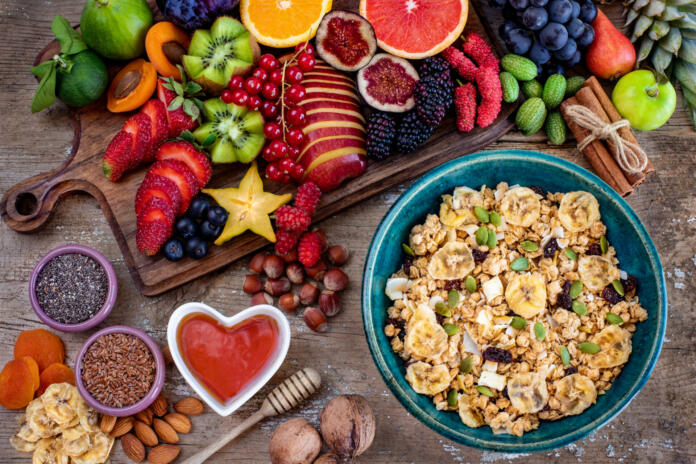 Muesli and granola in the bowl with fruits and nuts.