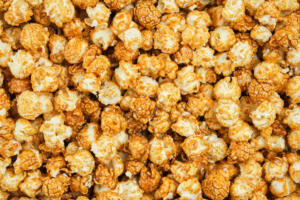 Popcorn background. Sweet caramel popcorn closeup, top view.