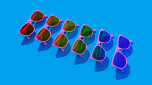 Rainbow Pride Tinted Pink Sunglasses Bright Summer Sun LGB LGBTQ Holiday Happiness with Bright Blue Background 3d illustration render