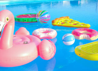 Napihljive blazine za počitek, užitek in nepozabne spomine CLOSE UP: Trendy inflatable toys float around the empty pool on a sunny day as all social gatherings are cancelled until further notice due to coronavirus outbreak. Empty pool after a cancelled party.