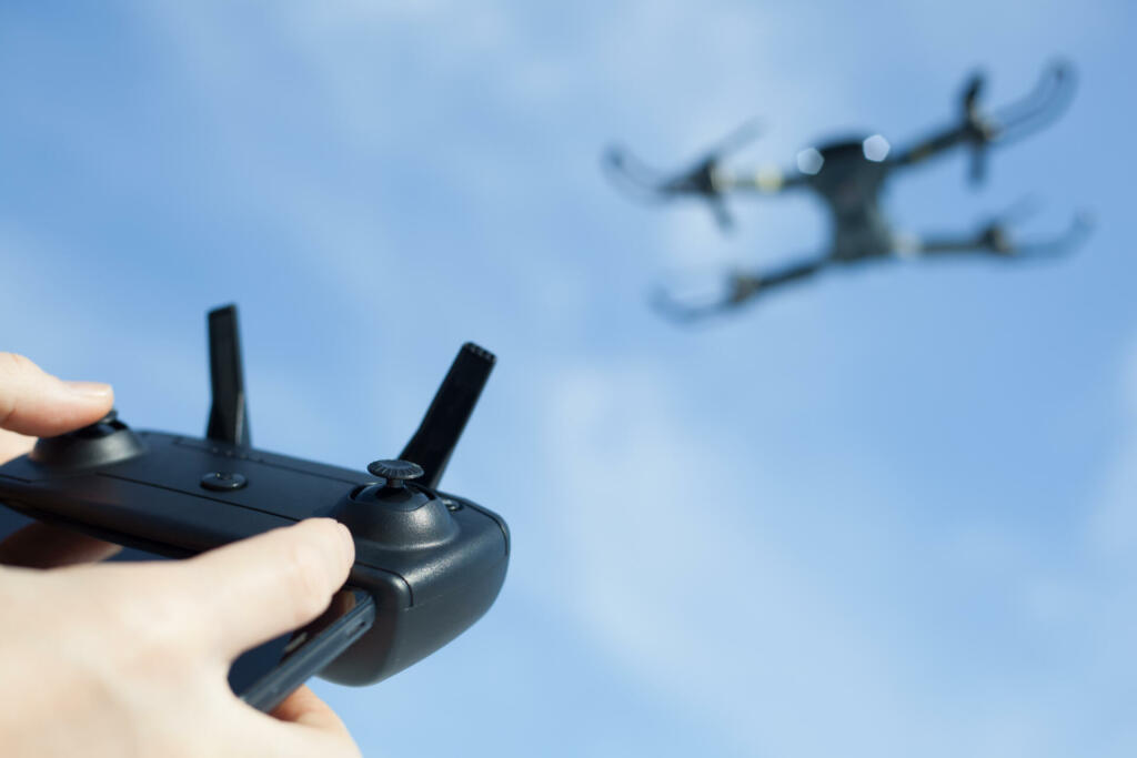 man operating drone using wireless controller