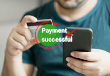 Odprtje prvega bančnega računa Man using smartphone and holding credit card with payment online successful screen, banking and shopping online. Transferring money online using applications