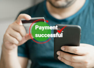 Odprtje prvega bančnega računa Man using smartphone and holding credit card with payment online successful screen, banking and shopping online. Transferring money online using applications