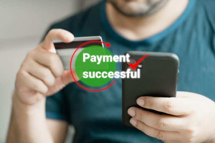 Man using smartphone and holding credit card with payment online successful screen, banking and shopping online. Transferring money online using applications