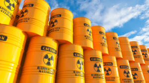Storage of yellow barrels with nuclear waste on outdoor sky. 3d render