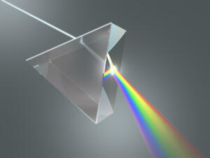 The crystal prism disperses white light into many colors.