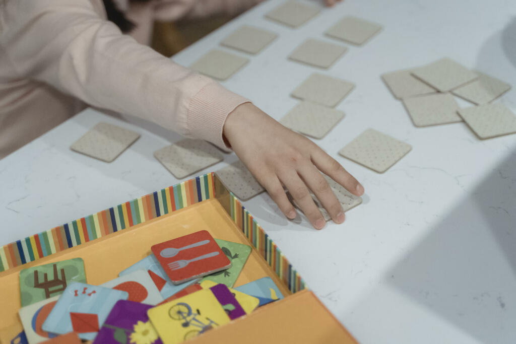 A person s hand touching a card