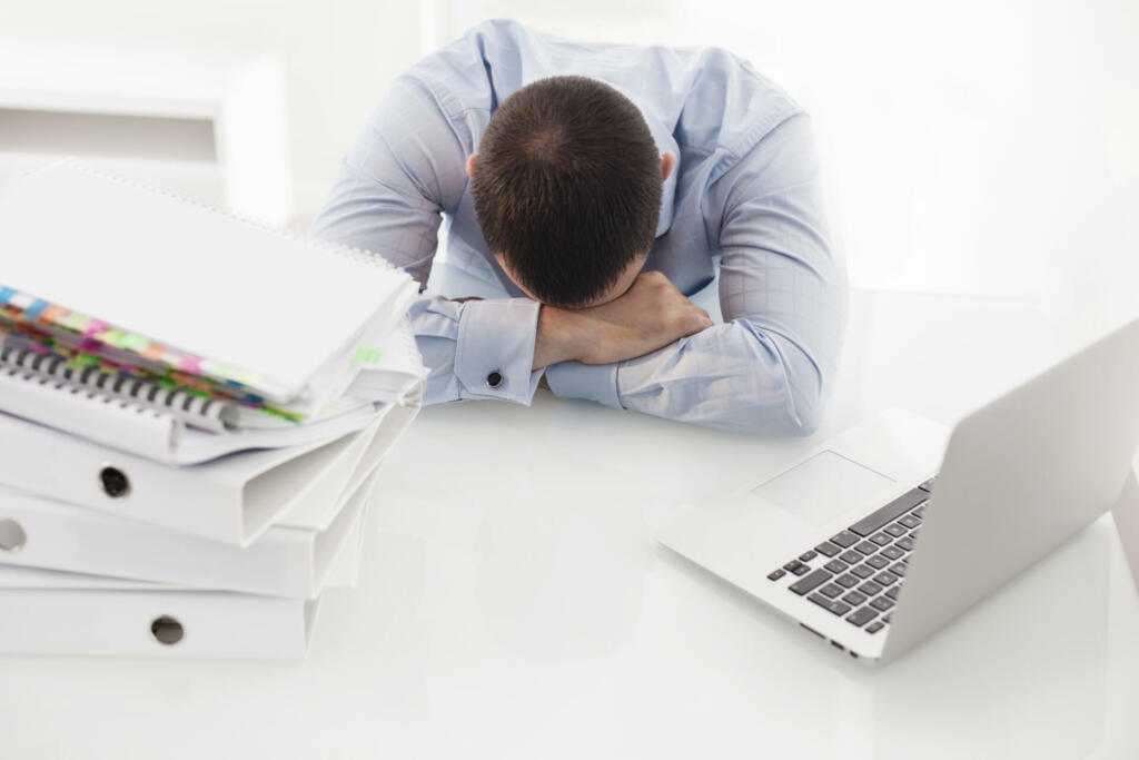 Caucasian businessman asleep at his desk