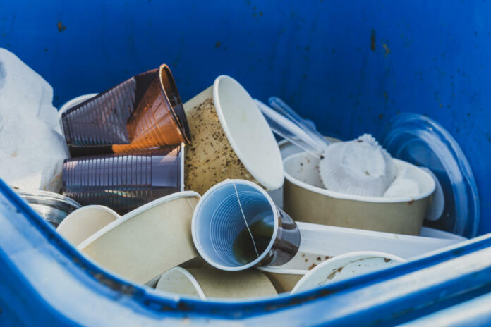 Garbage Bin Full of Single Use Plastic Trash, Plastic Cups, Trays, Plates and Food Packages with Leftovers. Say No to Single Use Plastic Concept.