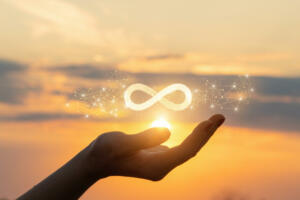 The concept of unlimited Internet. Hand shows the sign of infinity in the sun.