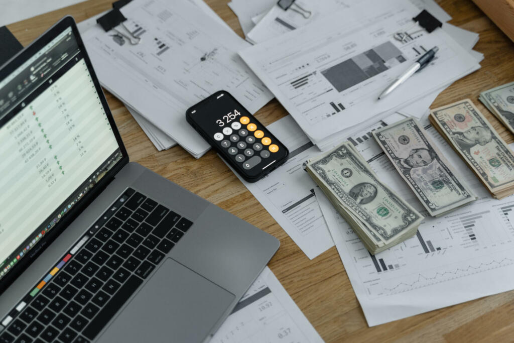 Banknotes and calculator on table