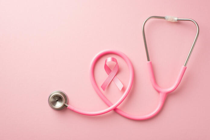 Breast cancer awareness concept. Top view photo of pink silk ribbon and stethoscope on isolated pastel pink background