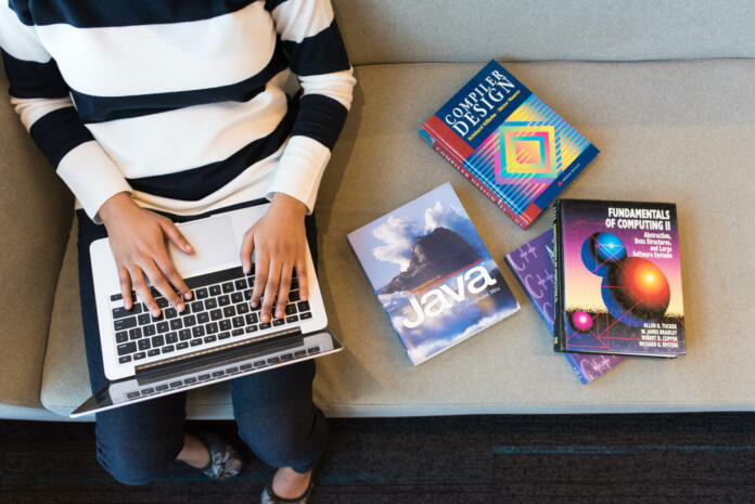 person-using-macbook-pro-on-person-s-lap-stockpack-pexels Person using macbook pro on person s lap