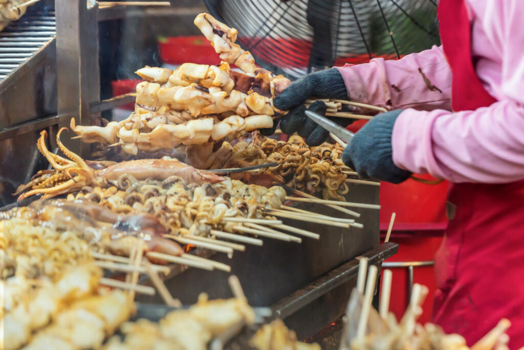 Street food options include seafood-stuffed grilled squid, unusual Asian cuisine, and charcoal-grilled squid.