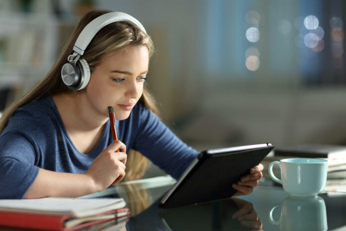 Student e-learning with tablet and headphones