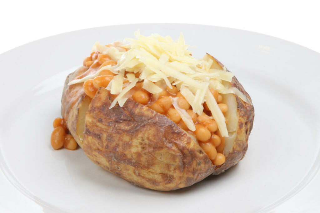 Baked potato filled with baked beans and topped with Cheddar cheese