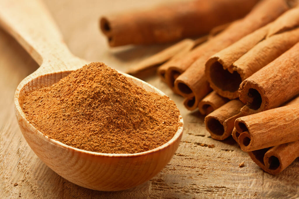 Cinnamon sticks and powder, studio shot, wood surface,