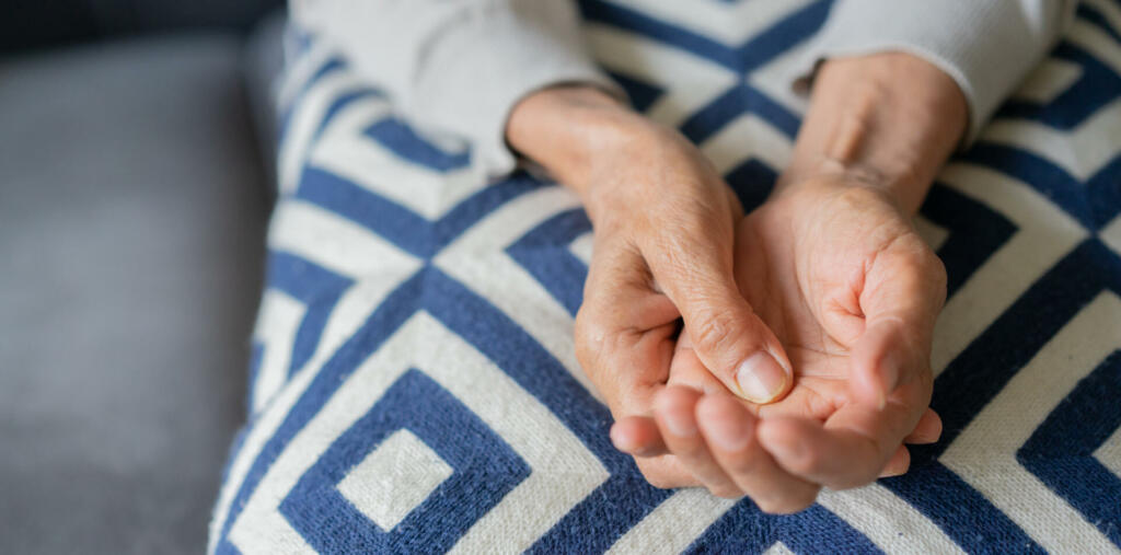 close up senior woman massage on hand to relief pain for treatment about chronic illness health care concept