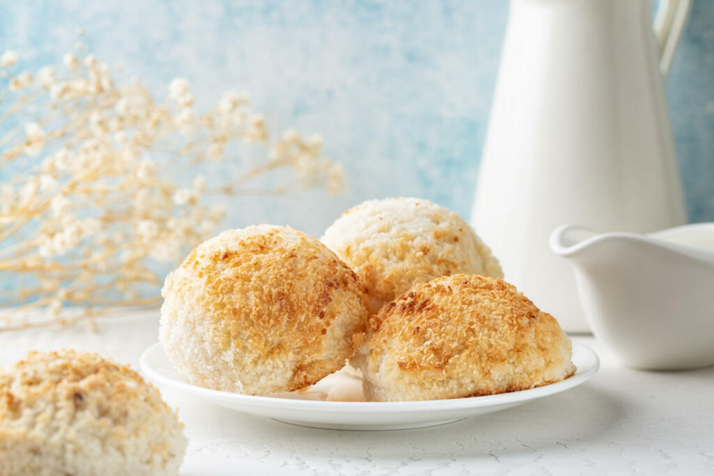 Coconut macaroons, small cake or biscuit, cookies. Morning table. White and light blue background.