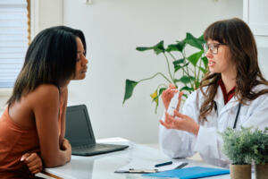 doctor giving nasal spray to female patient healthcare