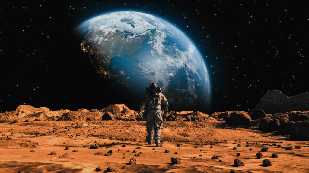 Following Shot of Brave Astronaut in Space Suit Confidently Walking on Mars Towards Earth Planet. Earth Planet as viewed from Mars surface. The surface of Mars, strewn with small rocks and red sand. Martian landscape in rusty orange shades, Mars Planet surface, Desert, Cliffs, sand. Red planet mars. Alien Red Planet Covered in Rocks. First Astronaut On the Mars. Big Moment for the Human Race. Advanced Technologies, Space Exploration/ Travel, Colonization Concept.