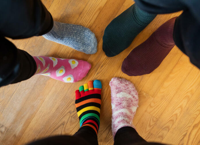 Funny family legs in mismatched socks.  Social networks photo for World Down Syndrome Day, March 21