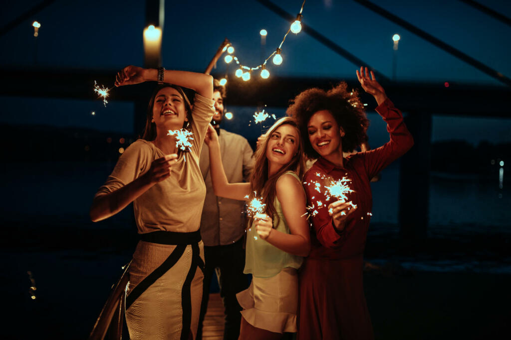 Group of friends having fun at the party near the river