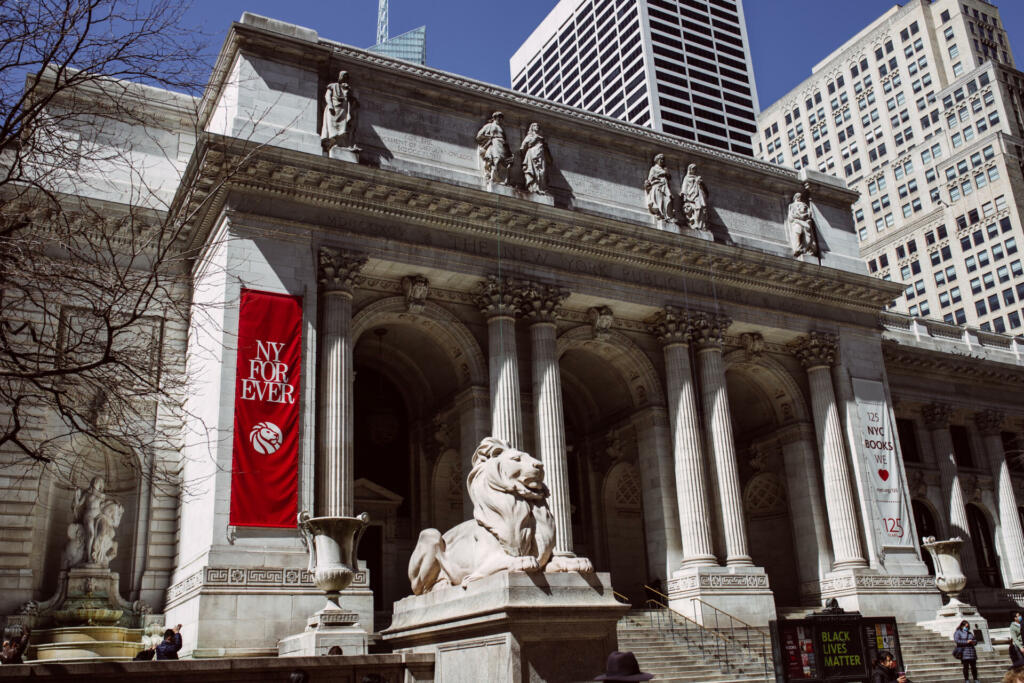 Manhattan, New York City, USA - March, 29. New York Public Library and poster "New York forever"